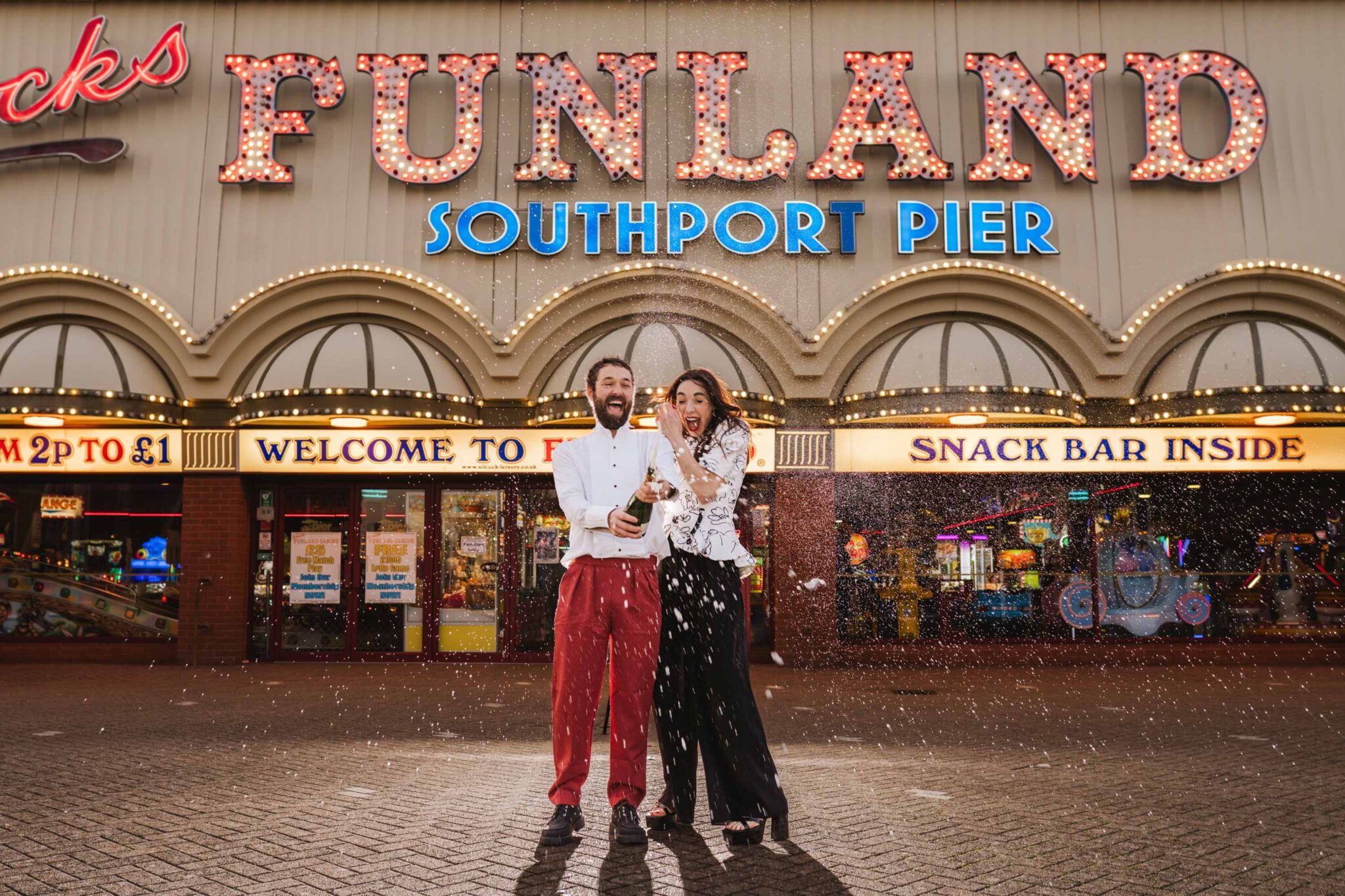 Bride and Groom shaking a bottle of champaign