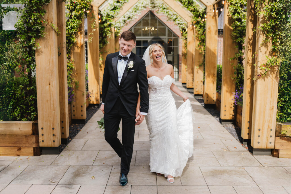 Couple walking laughing at Bartle Hall Preston