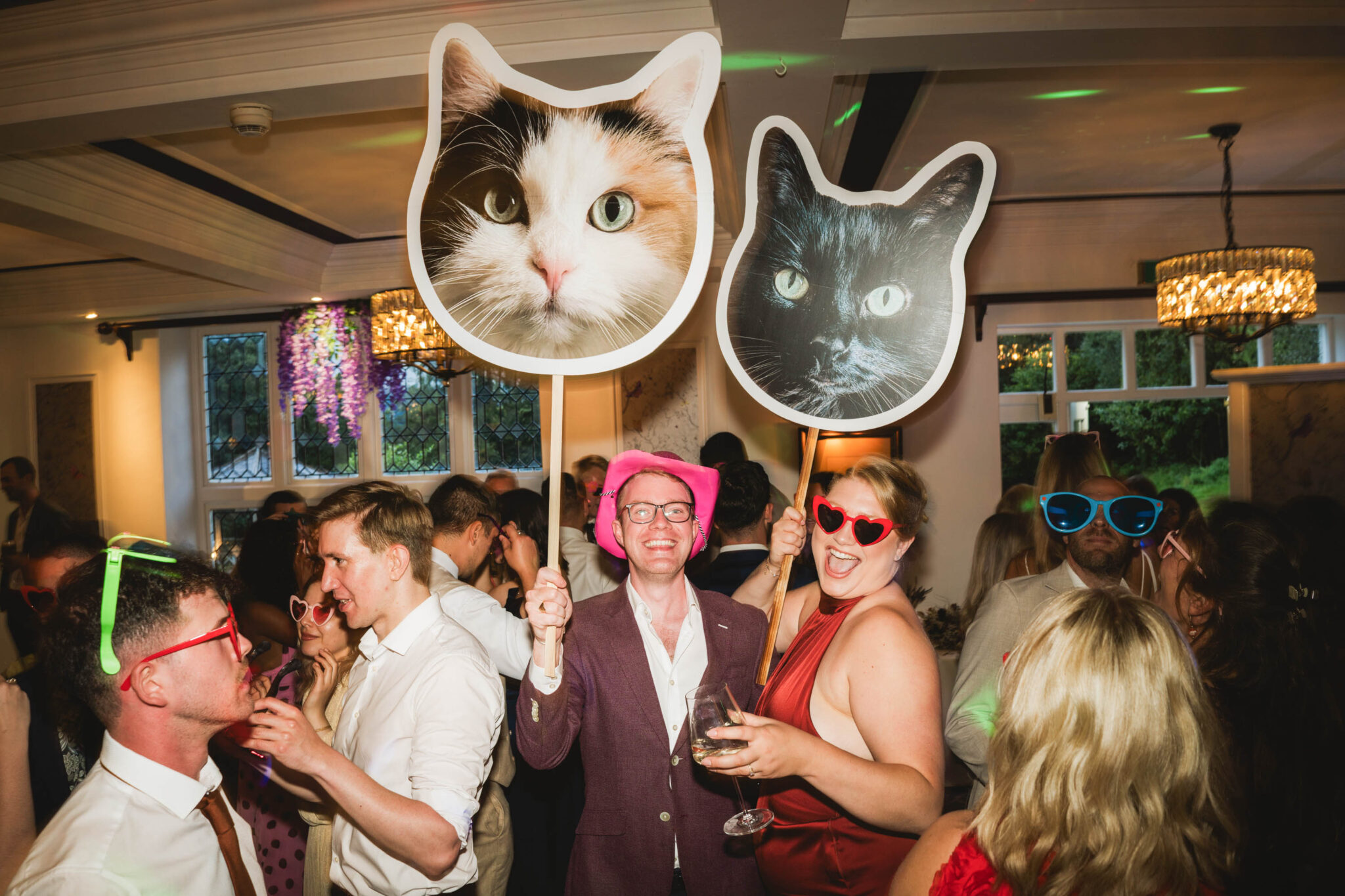 Wedding guests dancing with cat mascots